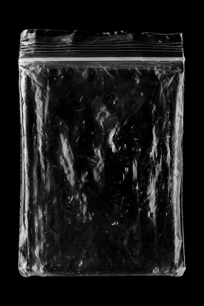 Photo blank transparent plastic bag overlay on black background