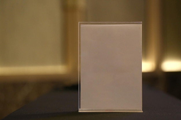 Blank and vacant white sign on a desk in a conference room
