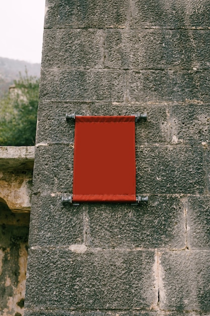 Blank vertical fabric plaque on an old building