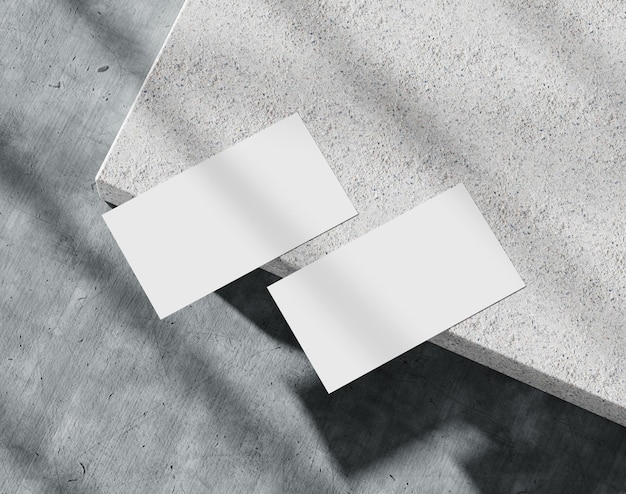 Blank white business card on the concrete branding paper