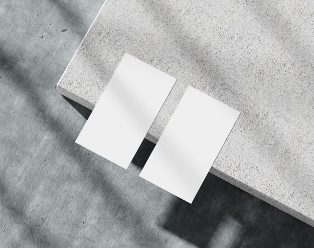 Blank white business card on the concrete branding paper