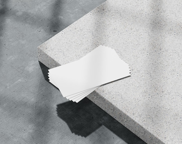 Blank white business card on the concrete branding paper