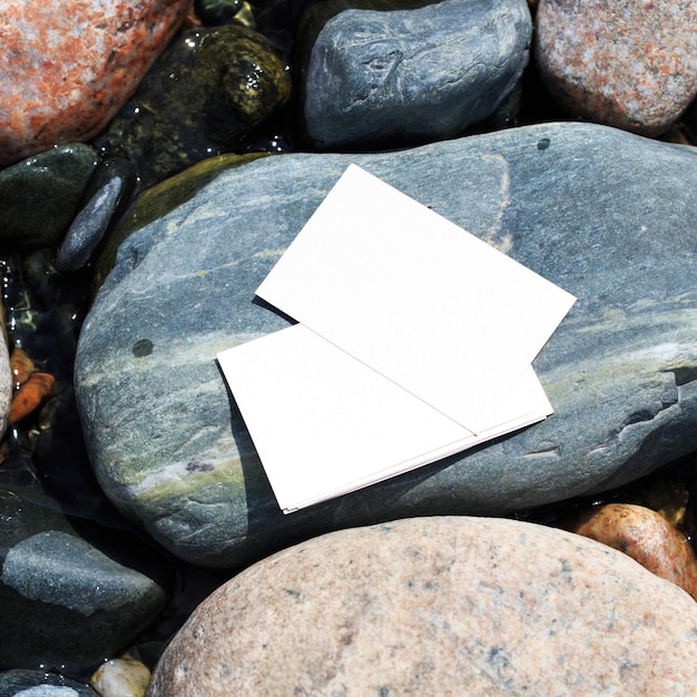 Blank white business card mockup on a background of stones For your business card design Corporate Stationery Branding Mock up