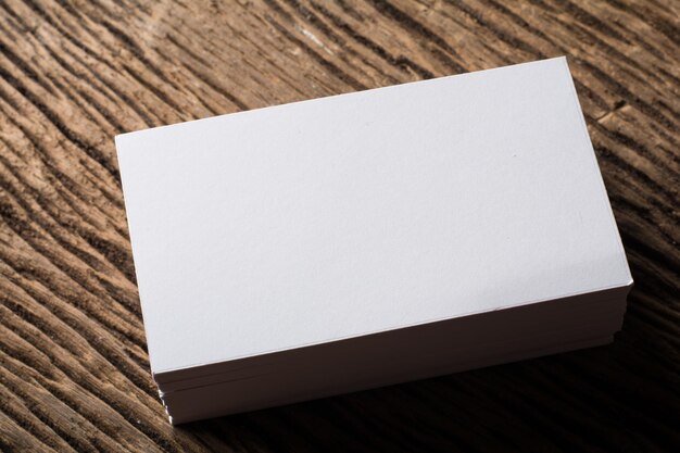Photo blank white business card presentation of corporate identity on wood background