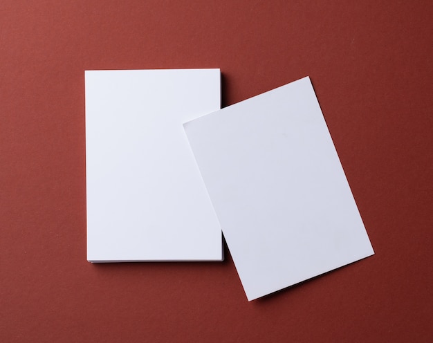 Blank white business cards on burgundy paper