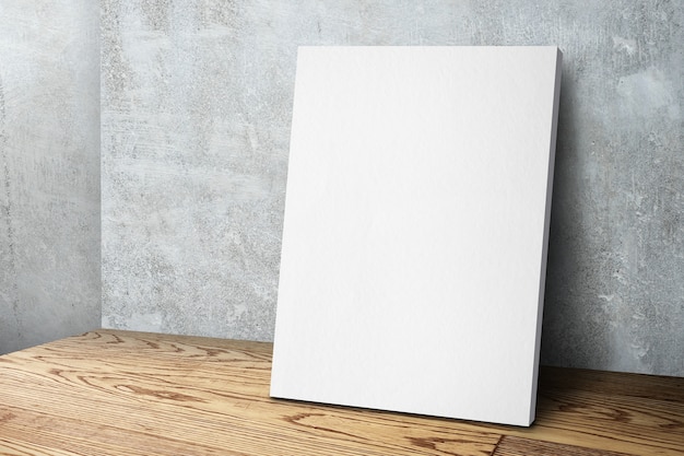Photo blank white canvas frame leaning at concrete wall and wood floor