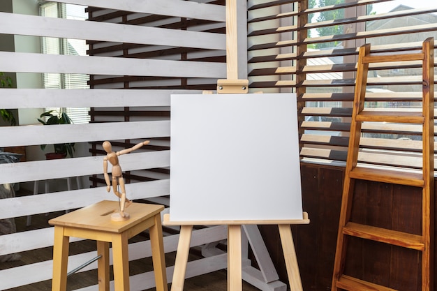 Blank white canvas on wooden easel