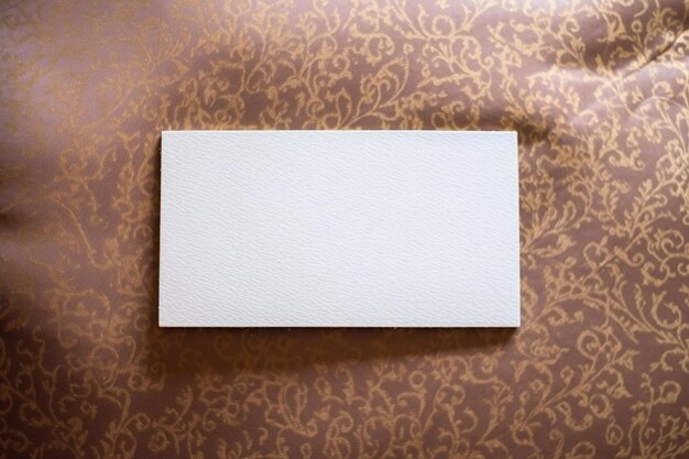 Photo a blank white card sitting on top of a pillow
