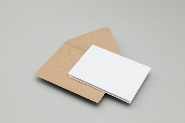 Blank white card with kraft brown paper envelope template mock up