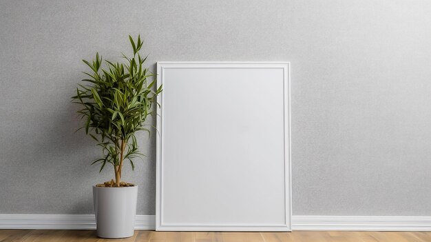 A blank white frame against a grey wall with a plant in it.