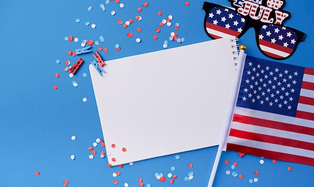 Blank white frame for mockup design on american national flag blue background with decorations