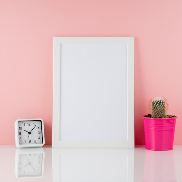 Blank white frame, plant cactus in pink pot on white table again