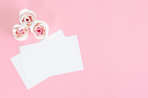 Blank white greeting card with pink rose flowers Mock up