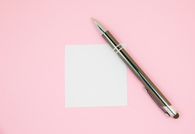 Blank white To Do List Sticker with pen. Searching information on the Internet.
Close up of reminder note paper on the pink background. Copy space. Minimalism, original and creative.