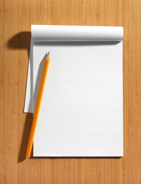 Blank white notepad with a pencil