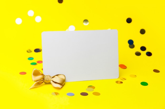 Blank white page mock up and sparkles confetti on yellow