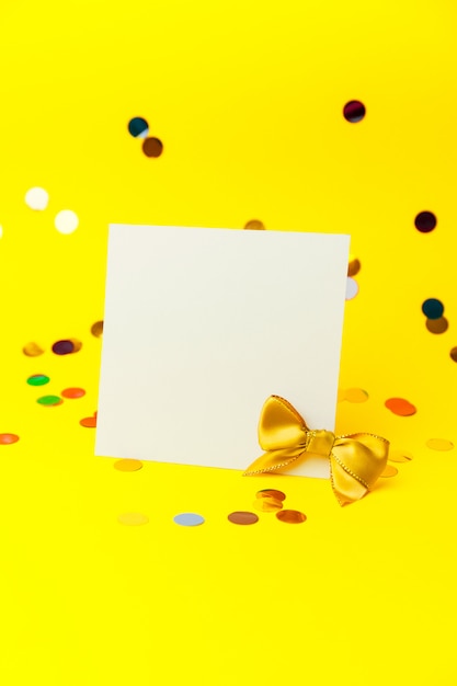 Photo blank white page mock up and sparkles confetti on yellow.