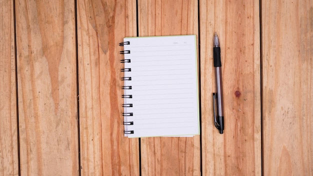 Blank white paper notes with pen on top wood table