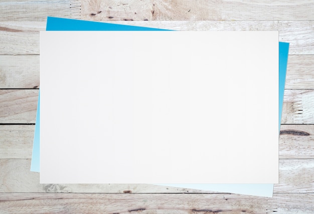 Photo blank white paper on old wooden background for text input