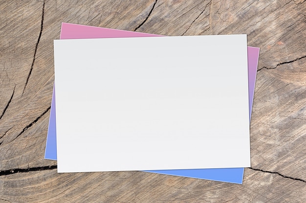 Photo blank white paper on old wooden background for text input.