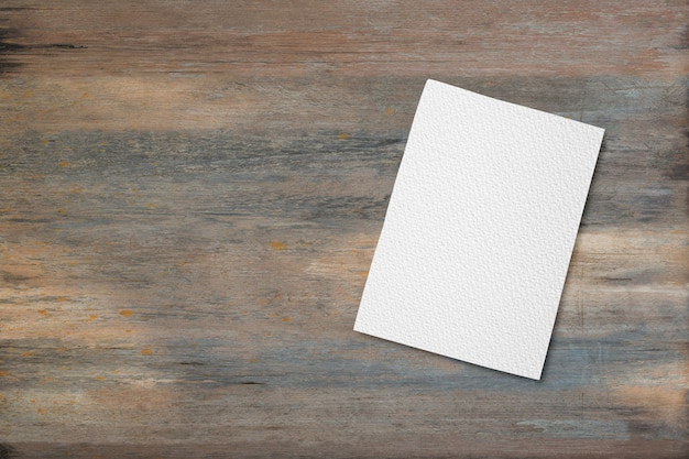 Photo blank white paper on wooden desk