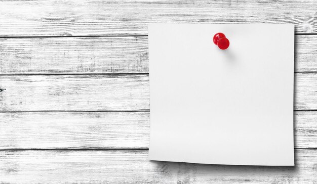 Blank white paper on wooden table background