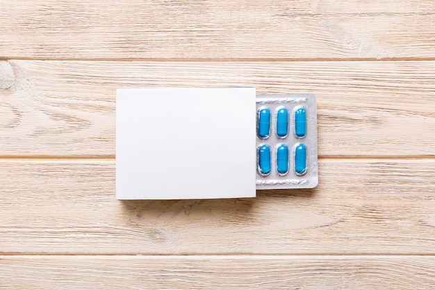 Photo blank white product package box mockup open blank medicine drug box with blue pills blister top view