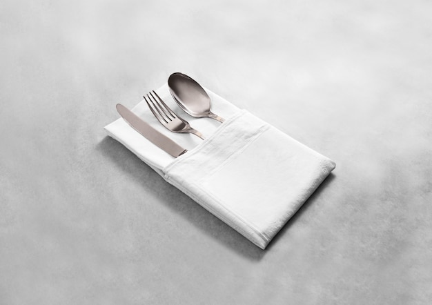 Blank white restaurant cloth napkin with silver cutlery set