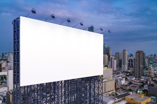 Blank white road billboard with Bangkok cityscape background at night time Street advertising poster mock up 3D rendering Side view The concept of marketing communication to sell idea