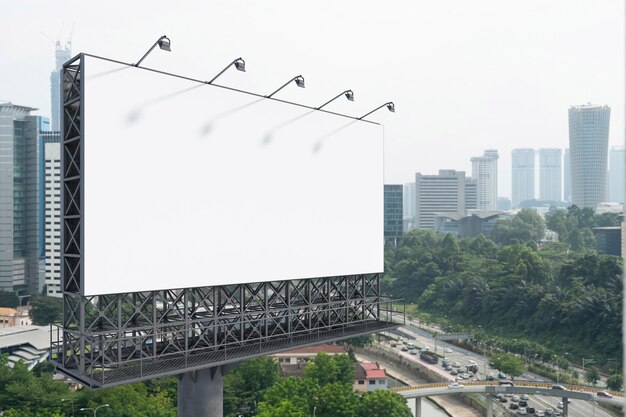 Blank white road billboard with KL cityscape background at day time Street advertising poster mock up 3D rendering Side view The concept of marketing communication to promote or sell idea