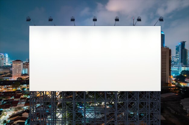 Blank white road billboard with KL cityscape background at night time Street advertising poster mock up 3D rendering Front view The concept of marketing communication to promote or sell idea