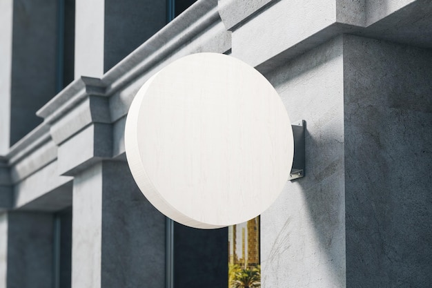 Blank white round banner on building wall