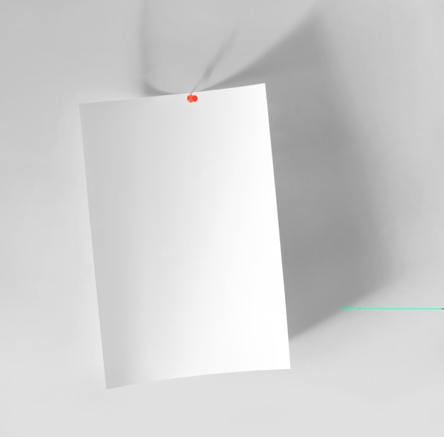 Blank white sheet of paper sticked on wall