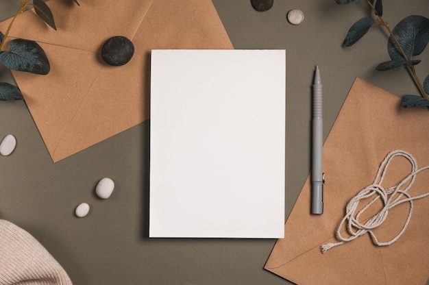 Blank white sheet of paper with an envelope brown background