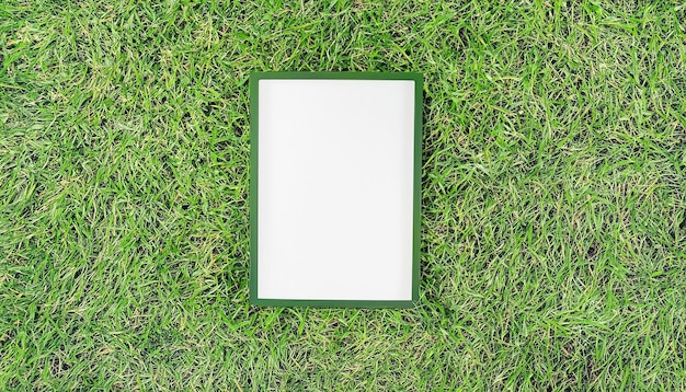 Blank white sign mockup on green lawn background closeup with selective focus