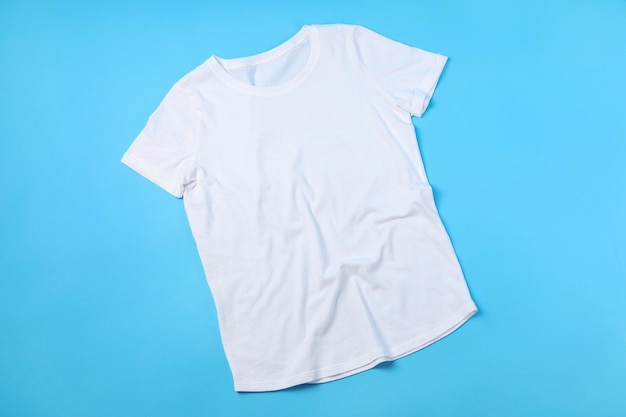 Blank white t-shirt with space for print on blue background