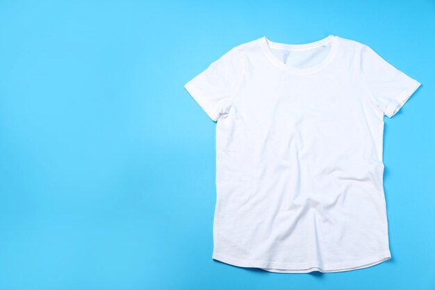 Photo blank white t-shirt with space for print on blue background