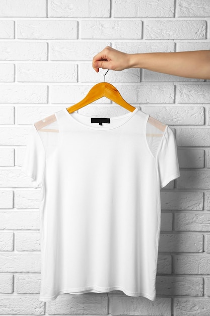 Photo blank white tshirt against brick wall