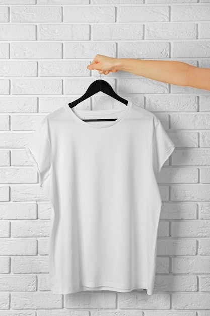 Blank white tshirt against brick wall