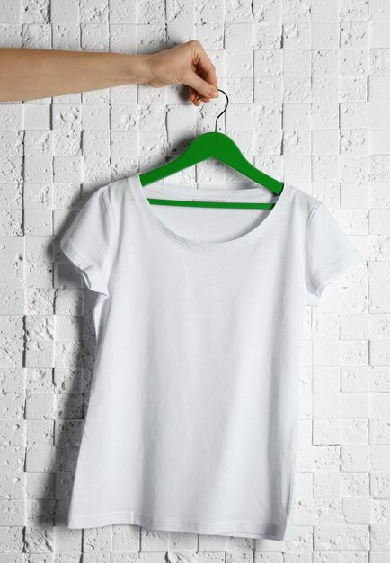 Photo blank white tshirt against light textured background