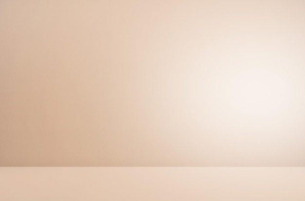 A blank white wall with a light brown background.