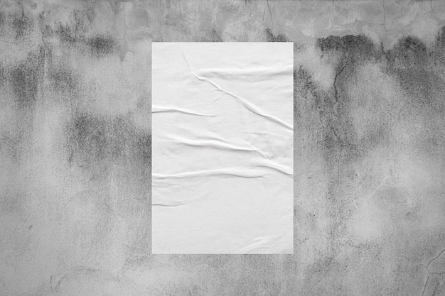 Photo blank white wheatpaste glued paper poster mockup on concrete wall background