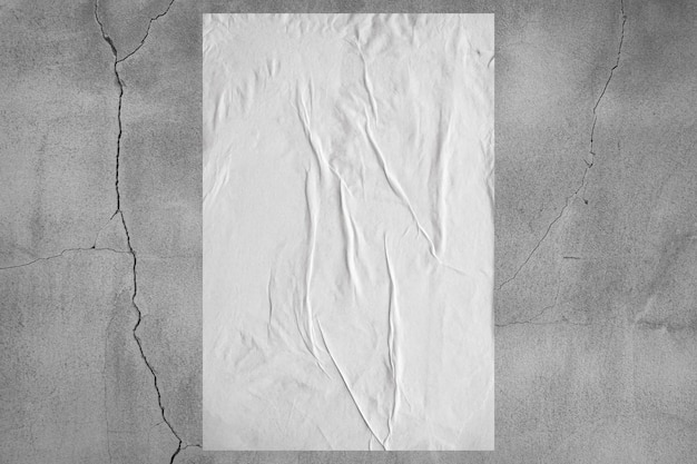 Blank white wheatpaste glued paper poster mockup on concrete wall background