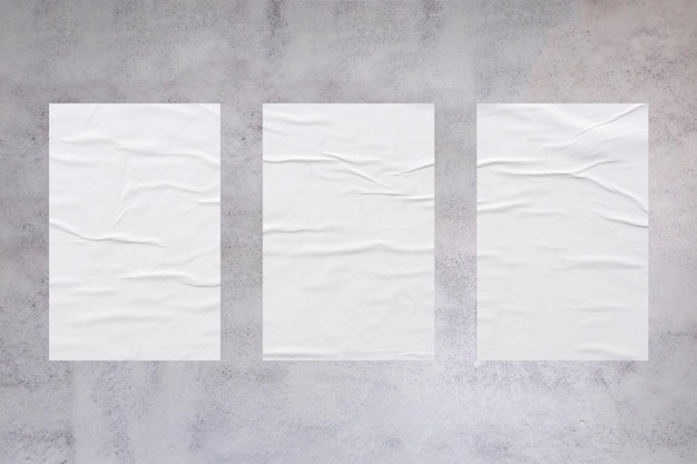 콘크리트 벽 배경에 빈 흰색 밀 페이스트 접착 종이 포스터 모형