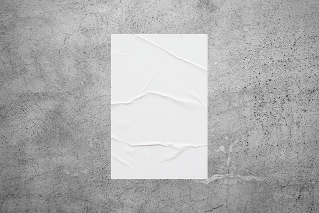 Photo blank white wheatpaste glued paper poster mockup on concrete wall background