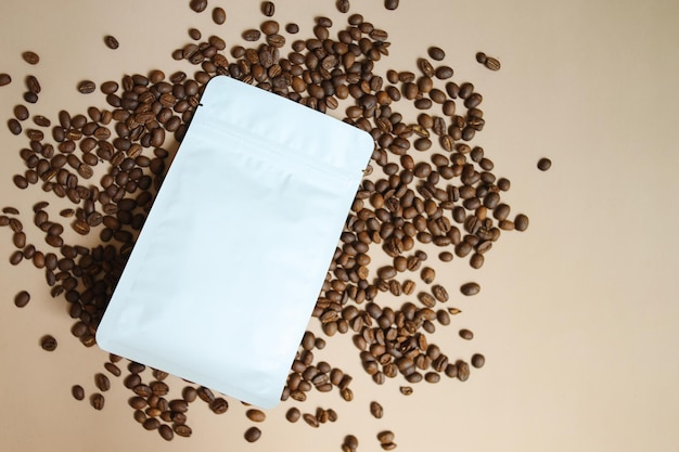 Blank White Ziplock Eco Packaging For Mockup Advertisement On Coffee Beans Over Beige Background