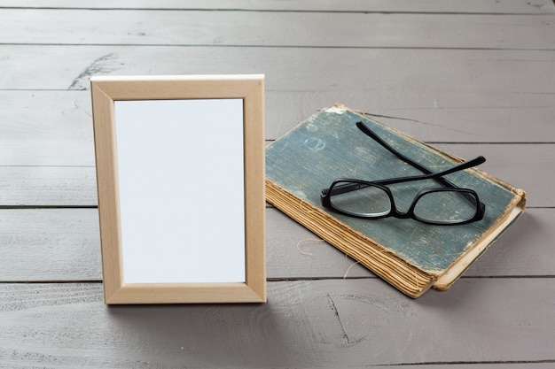 Blank wooden picture frame on wooden background