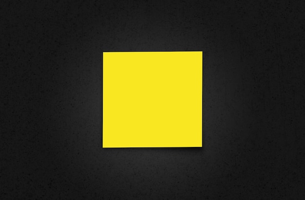 Blank yellow paper on black table background