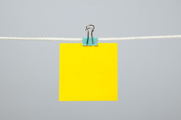 Photo blank yellow paper note on the string