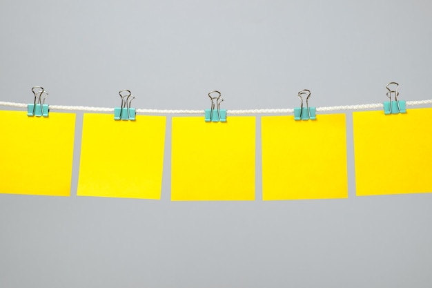 Blank yellow paper sheets on the string